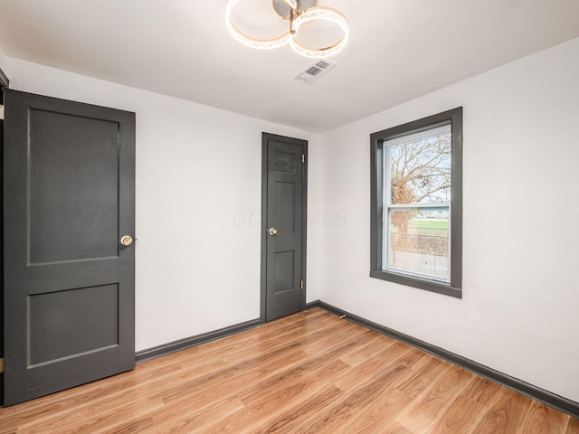 unfurnished room featuring light wood-type flooring