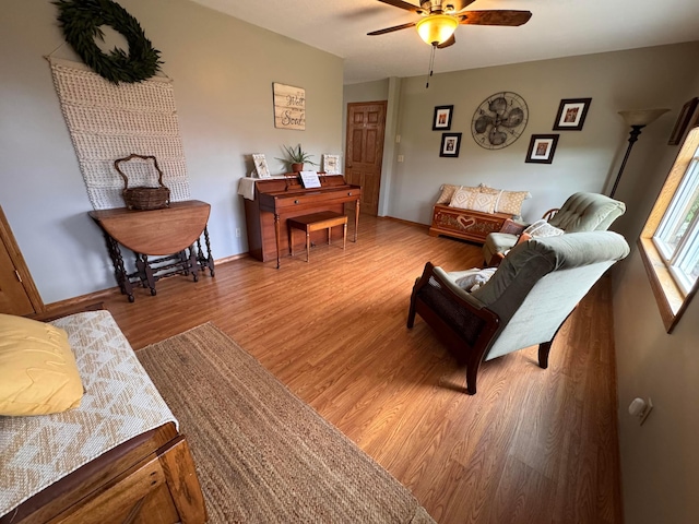 living room with hardwood / wood-style floors and ceiling fan