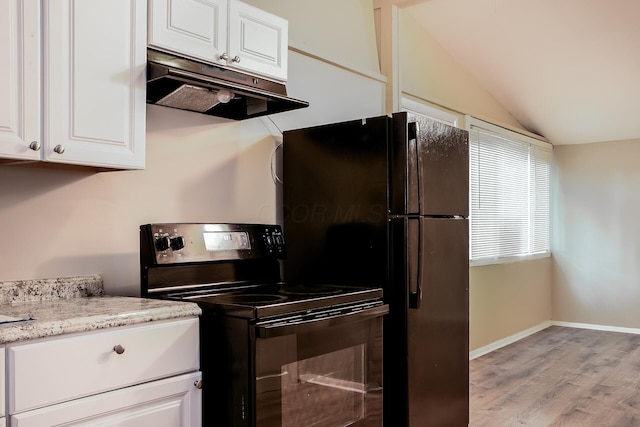 kitchen with light stone countertops, light wood-type flooring, black appliances, white cabinetry, and lofted ceiling