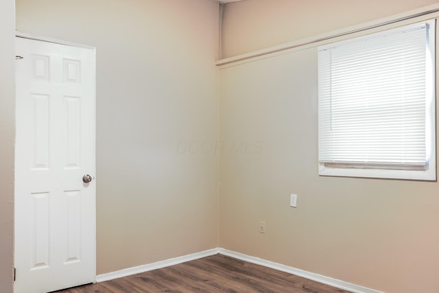 spare room featuring dark hardwood / wood-style flooring