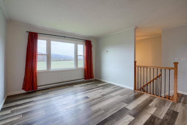 spare room with light hardwood / wood-style flooring, baseboard heating, and ornamental molding