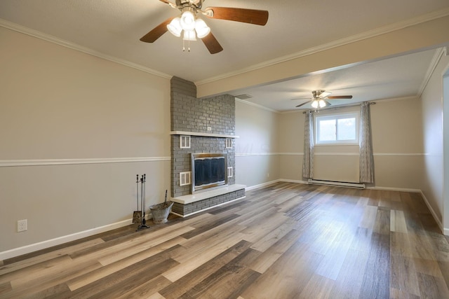 unfurnished living room featuring a baseboard heating unit, hardwood / wood-style flooring, a brick fireplace, and ornamental molding