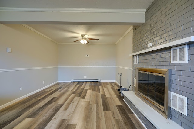 unfurnished living room featuring hardwood / wood-style floors, a brick fireplace, baseboard heating, and ornamental molding