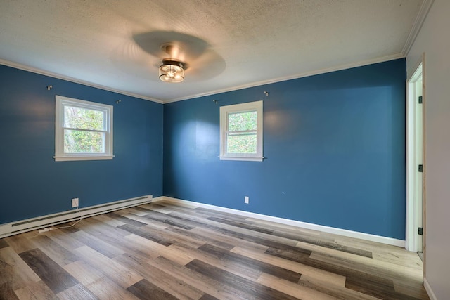 unfurnished room featuring plenty of natural light, wood-type flooring, and a textured ceiling