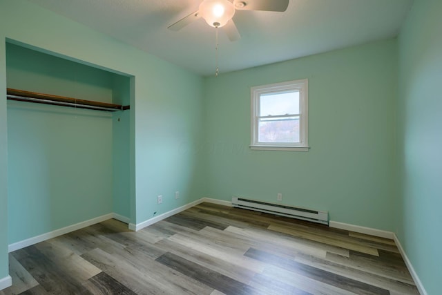 unfurnished bedroom with ceiling fan, a closet, a baseboard radiator, and light hardwood / wood-style floors