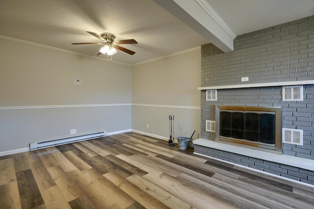 unfurnished living room featuring light wood-type flooring, ornamental molding, a textured ceiling, a baseboard heating unit, and a fireplace