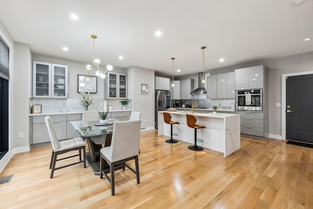 dining room featuring light hardwood / wood-style floors and sink