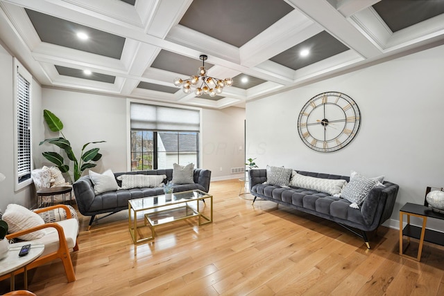 living room featuring coffered ceiling, light hardwood / wood-style flooring, ornamental molding, beam ceiling, and a chandelier