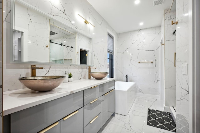 bathroom with vanity and separate shower and tub