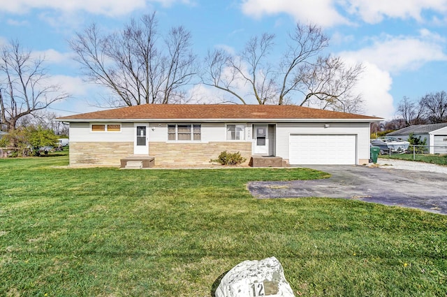 single story home with a garage and a front lawn