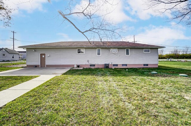 back of house featuring a lawn, a patio area, and central AC