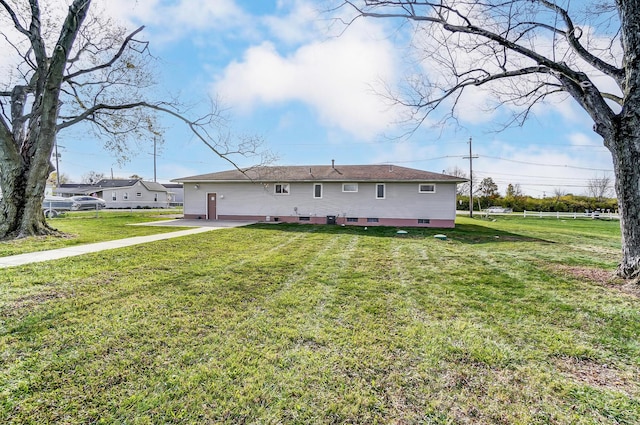 rear view of house with a patio area and a lawn