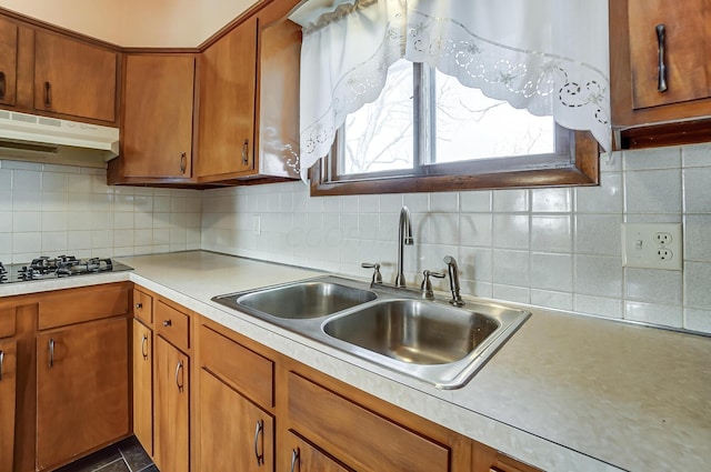 kitchen with backsplash, black gas stovetop, and sink