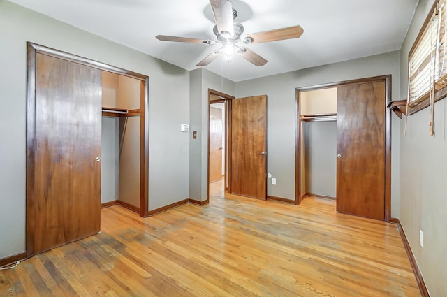 unfurnished bedroom with multiple closets, ceiling fan, and light hardwood / wood-style flooring