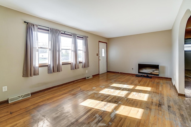 unfurnished living room featuring light wood-type flooring