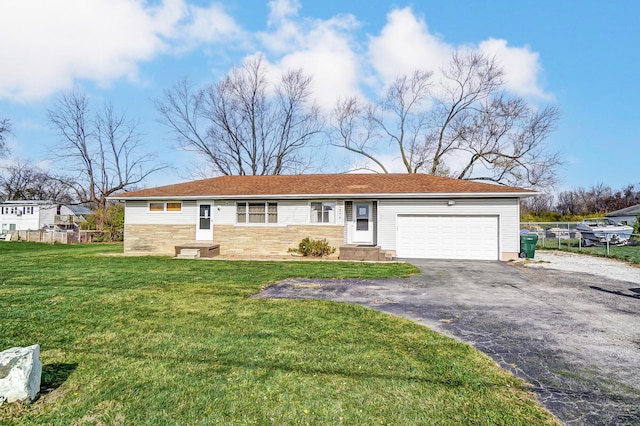 ranch-style house featuring a garage and a front lawn