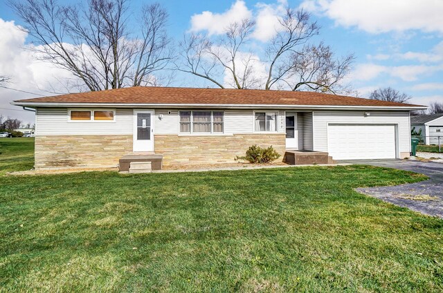 single story home featuring a garage and a front lawn