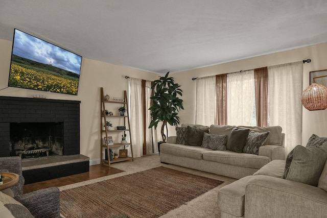 living room featuring a brick fireplace