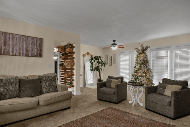 carpeted living room featuring ceiling fan