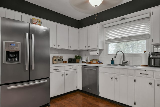 kitchen featuring tasteful backsplash, white cabinetry, sink, and stainless steel appliances