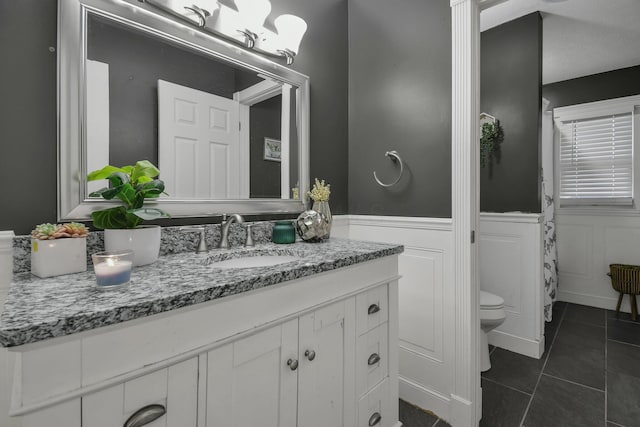 bathroom featuring tile patterned floors, vanity, and toilet