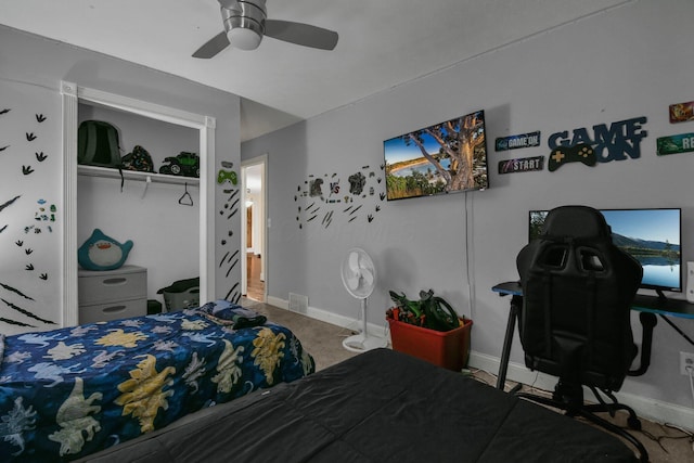 carpeted bedroom featuring ceiling fan and a closet