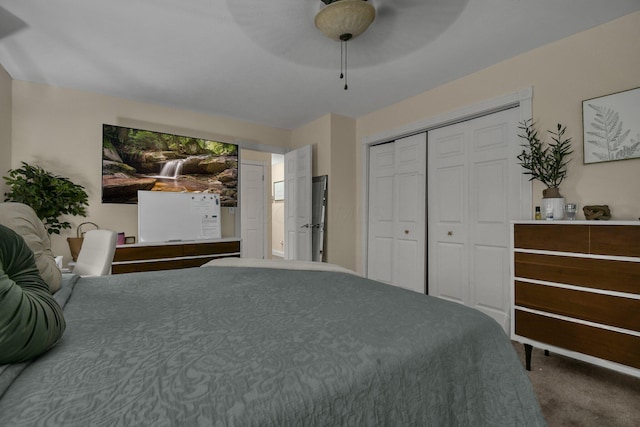 carpeted bedroom with a closet and ceiling fan