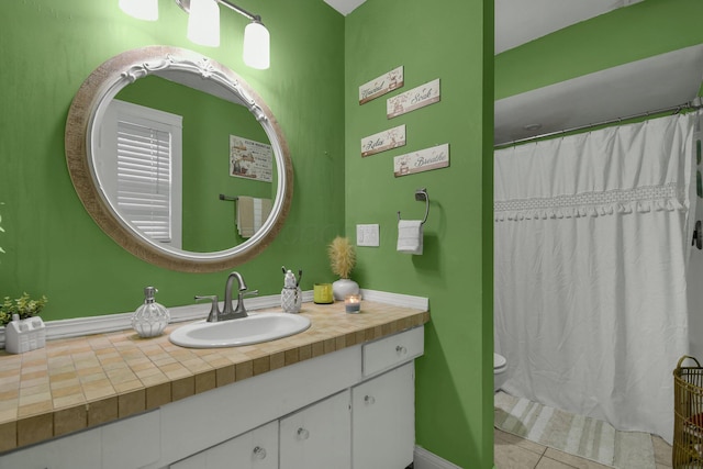 bathroom with tile patterned floors, vanity, curtained shower, and toilet