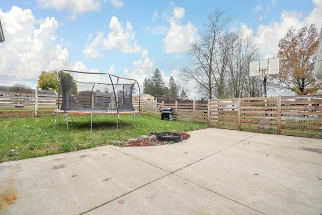 view of patio / terrace featuring an outdoor fire pit and a trampoline