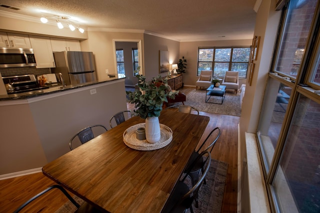39 Buttles Ave Unit 39, Columbus, OH 43215 - dining area featuring wood finished floors, crown molding, and a textured ceiling