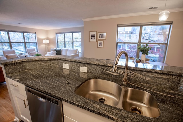 39 Buttles Ave Unit 39, Columbus, OH 43215 - kitchen featuring dishwasher, crown molding, dark stone countertops, white cabinetry, and open floor plan
