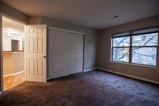 39 Buttles Ave Unit 39, Columbus, OH 43215 - unfurnished bedroom with dark carpet and a closet