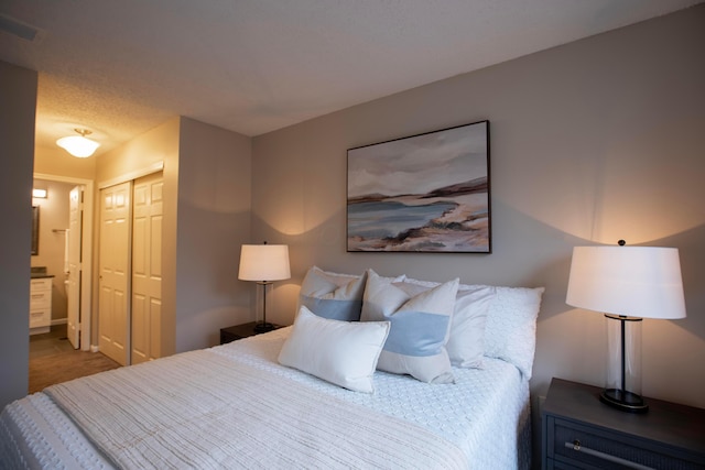 bedroom featuring ensuite bath and a closet