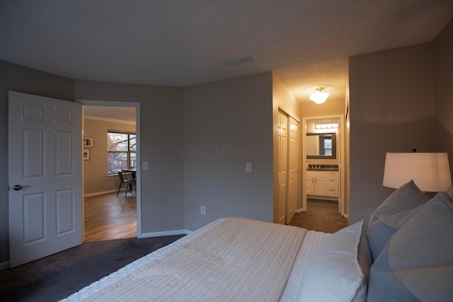 carpeted bedroom with ensuite bathroom