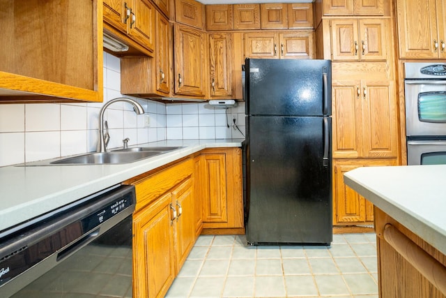 kitchen featuring decorative backsplash, sink, and black appliances