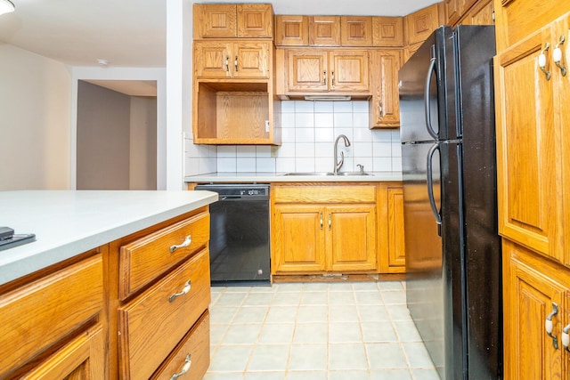 kitchen with black appliances, sink, and backsplash