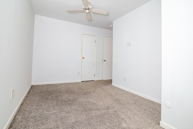 unfurnished room featuring ceiling fan and carpet floors