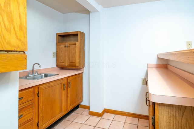 kitchen with light tile patterned flooring and sink