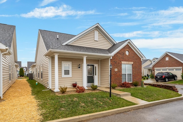 view of front of property featuring a front yard and central air condition unit