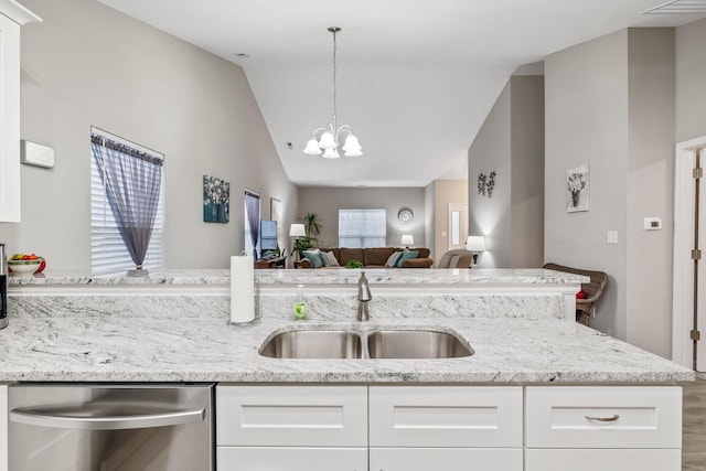 kitchen with white cabinetry, sink, dishwasher, and lofted ceiling