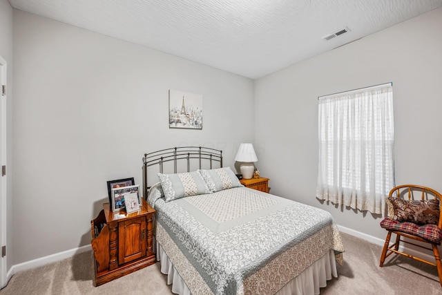 carpeted bedroom with a textured ceiling