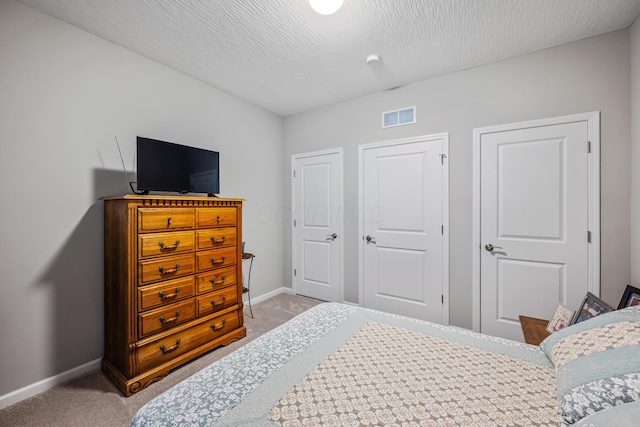 carpeted bedroom with a textured ceiling