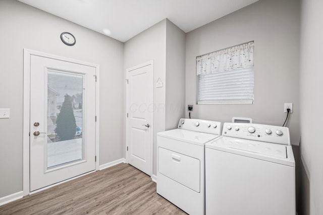 laundry room featuring independent washer and dryer and light wood-type flooring