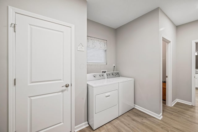 laundry area featuring independent washer and dryer and light wood-type flooring