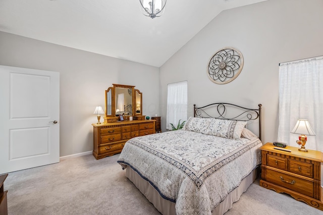 carpeted bedroom featuring high vaulted ceiling