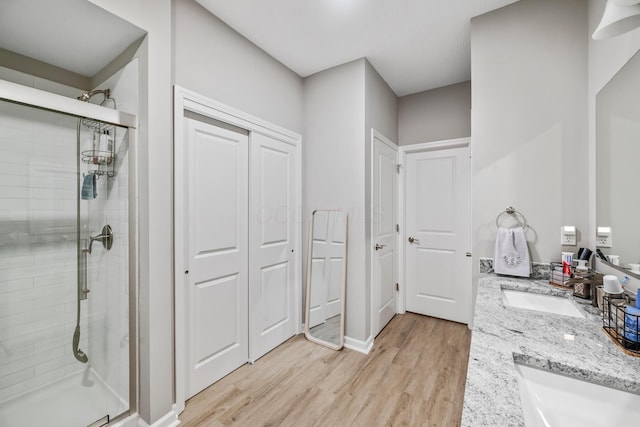 bathroom featuring vanity, hardwood / wood-style flooring, and an enclosed shower