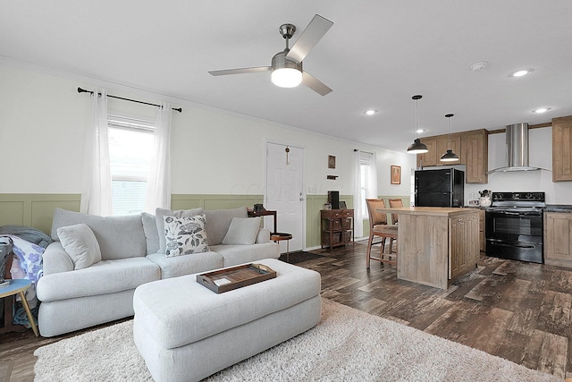 living room with ceiling fan and dark hardwood / wood-style floors