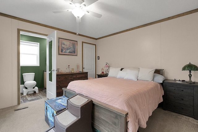 carpeted bedroom featuring ceiling fan, crown molding, and a textured ceiling