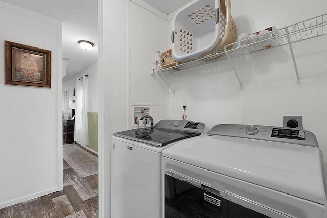 laundry area with dark hardwood / wood-style floors and independent washer and dryer