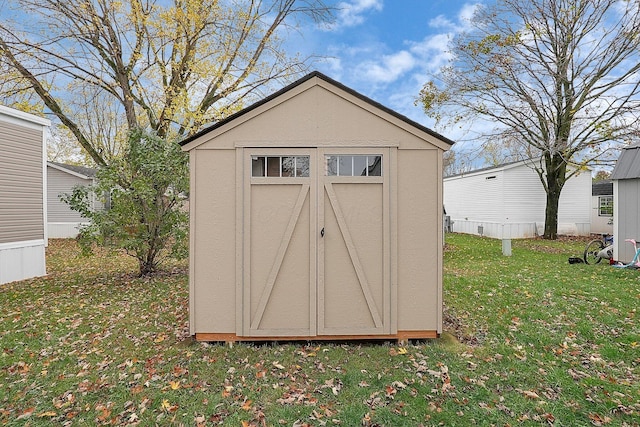 view of outbuilding featuring a yard